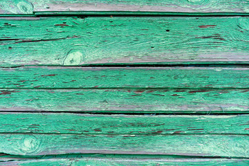 old wooden boards with peeling green paint. The green paint will come off the wooden planks. Green Paint with old wooden surface