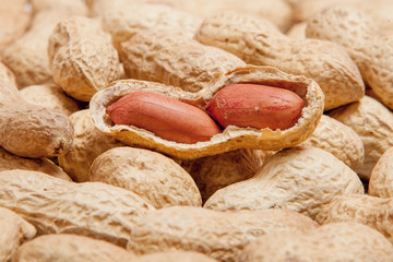 Large peeled peanuts close-up of beans in the shell. Unpeeled peanuts in the shell. Peanuts, for background or texture. Growing organic protein. Macro