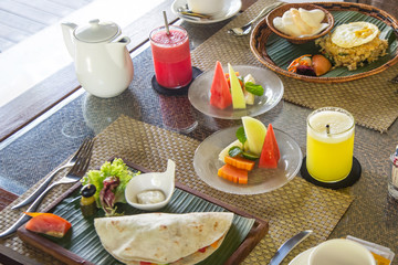 Meals served on the table, tortilla, rice, fresh fruits and juices