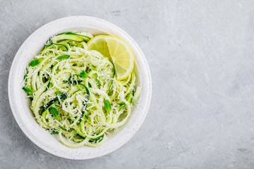 Green vegetarian pasta. Spiralized zucchini noodles with mint, lemon and parmesan cheese