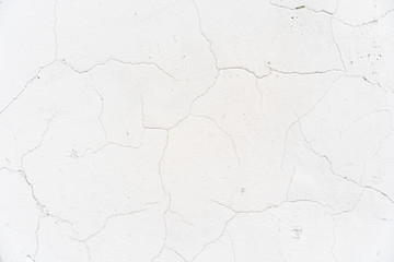 background cracked white wall. White plaster cracked. Cracks on the white wall. Grid on a white plaster wall texture.