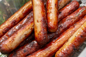 sausages are fried in the grill with smoke