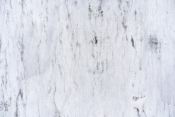 background shabby white wall. White plaster with scuffs. Scuffed on a white wall. Old white plaster wall texture.