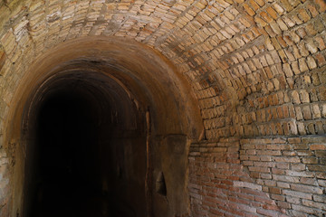 Image of vintage brick wall tunnel from outside through inside. 