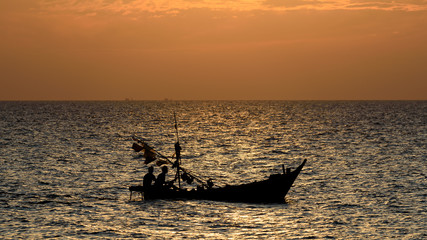 Fisherman boat in the sea with sunset sky