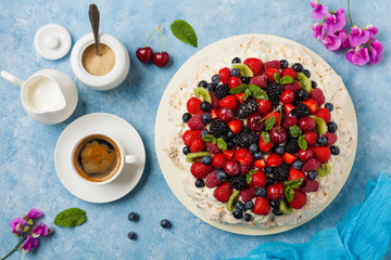 Meringue Pavlova cake with fresh fruit. Top view.