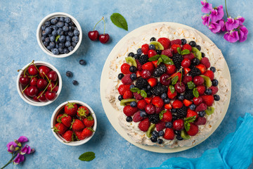Meringue Pavlova cake with fresh fruit. Top view.