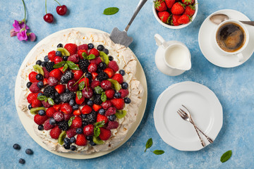 Meringue Pavlova cake with fresh fruit. Top view.