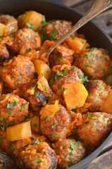 Fried meatballs with potatoes in a pan