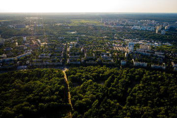 Aerial view of the sunny city near parks and trees
