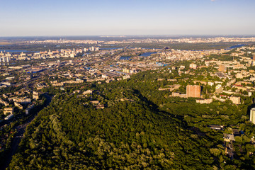 Aerial view of the sunny city near parks and trees