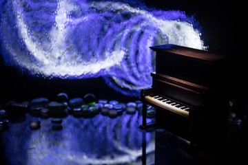 Creative concept. Artwork decoration with piano on dark toned foggy background with light.