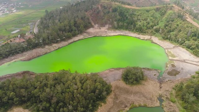 volcanic sulfur lake telaga warna in dieng plateau, java Indonesia. mountain tropical landscape lake with green water among mountains. this lake is one mainstay tourist destinations in Wonosobo