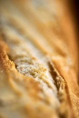 Detailed macro close up shot of french bread baguette out of oven fresh warm cooked baked crunchy crust toast.