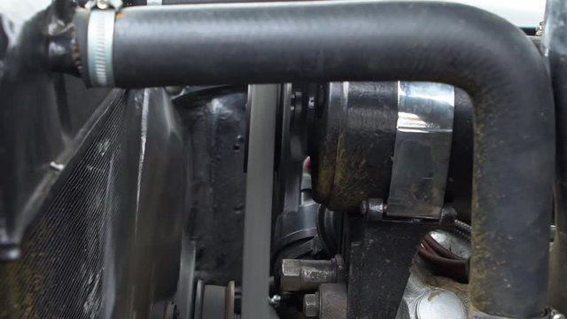 Slow Motion of Black vintage car engine under hood of a classic American Ford Mercury Eight. See the radiator cooling panel Engine and electronic system for mechanic-Dan