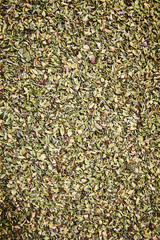 Oregano spice detail macro texture background pattern. Spilled oregano spice macro. Bowl, restaurant activity for pizzas