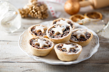 Homemade festive mince pies on white plate © marysckin