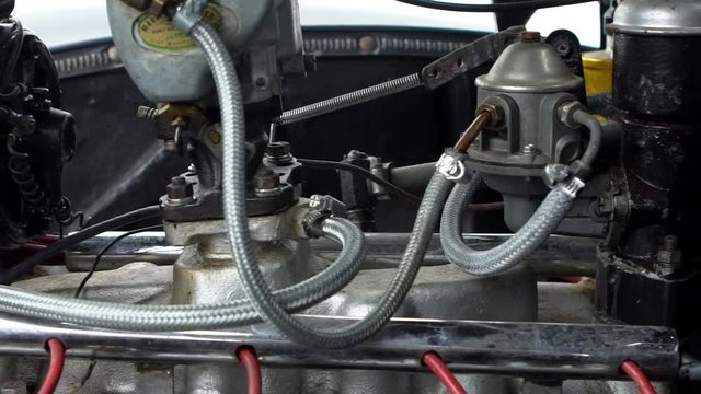 Slow Motion of Black vintage car engine under hood of a classic American Ford Mercury Eight. See the radiator cooling panel Engine and electronic system for mechanic-Dan