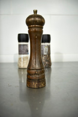 Wooden pepper mill. Traditional old vintage restaurant seasoning item.