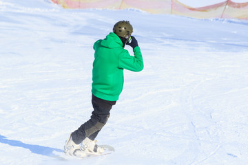 one snowboarder snowboarding in winter mountains