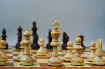  Chess on a chessboard on a gray background. Move e2-e4