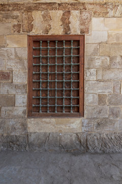Mamluk era wooden closed window with wooden ornate grid over stone bricks wall, Mosque of Aqsunqur (Blue Mosque), Bab Al Wazeer District, Old Cairo, Egypt