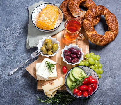 Traditional turkish breakfast with olives, simit bagels, feta cheese, tea, square image