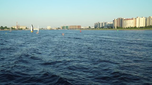 Panorama of the Neva River. The first perspective of a tourist person, standing on the deck of a cruise ship.