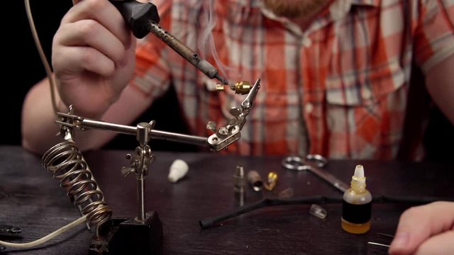 Process of replacing cable for audio rca connector. Muscled electrician solder wire with rosin soldering iron to male jack rca.