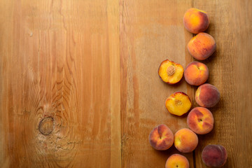 Fresh ripe peaches fruits on wooden rustic background. Top view.