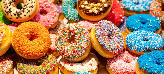 Doughnuts with colorful decoration background. Closeup view