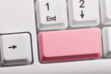 White pc keyboard with empty note paper above white background key copy space