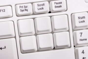 White pc keyboard with empty note paper above white background key copy space