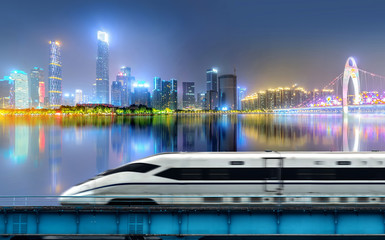 High-speed rail speeds on Bridges and the modern city skyline of guangzhou, China
