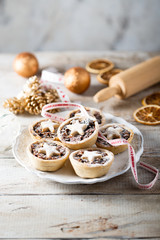 Homemade festive mince pies on white plate © marysckin