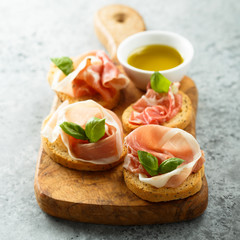 Italian appetizers with Parma ham and basil