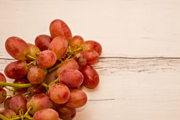 Red ripe grapes on wooden background