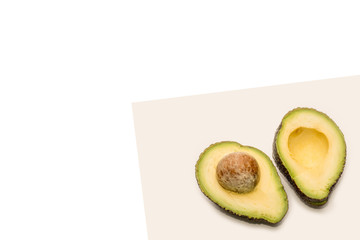 Ripe avocado cut in half on neutral background
