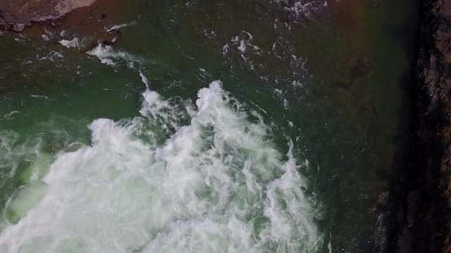 the water falls, aerial drone footage, downward view going downward, Kootenai falls, Montana. v04