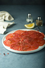 Homemade beef carpaccio with salt and pepper