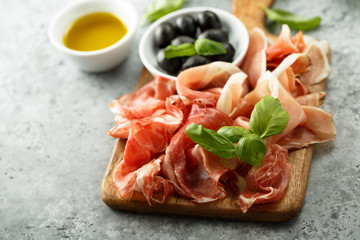Charcuterie board with fresh basil