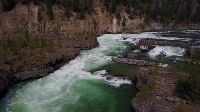 the water falls, aerial drone footage, downward view going upward, Kootenai falls, Montana. v02