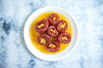 Sweet delicious and tasty Quince jam, quince marmalade dessert or quince cheese in plate on white table background from top view.