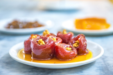 Sweet delicious and tasty Quince jam, quince marmalade dessert or quince cheese in plate on white table background from top view. Various fruit desserts or jams 