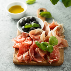 Charcuterie board with fresh basil