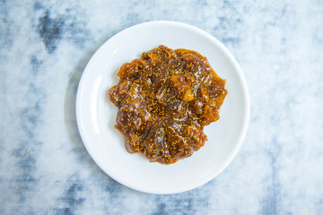 Sweet delicious and tasty fig jam or fig marmalade dessert in plate on white table background. Various fruit desserts or jams 