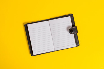 Dark leather private locked diary striped paper sheets colored background