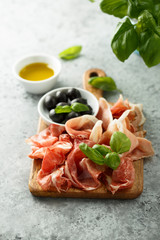 Charcuterie board with fresh basil