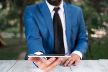 Businessman with mobile phone in his hand.