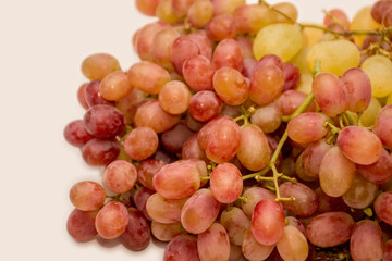 Red and white grapes on neutral background